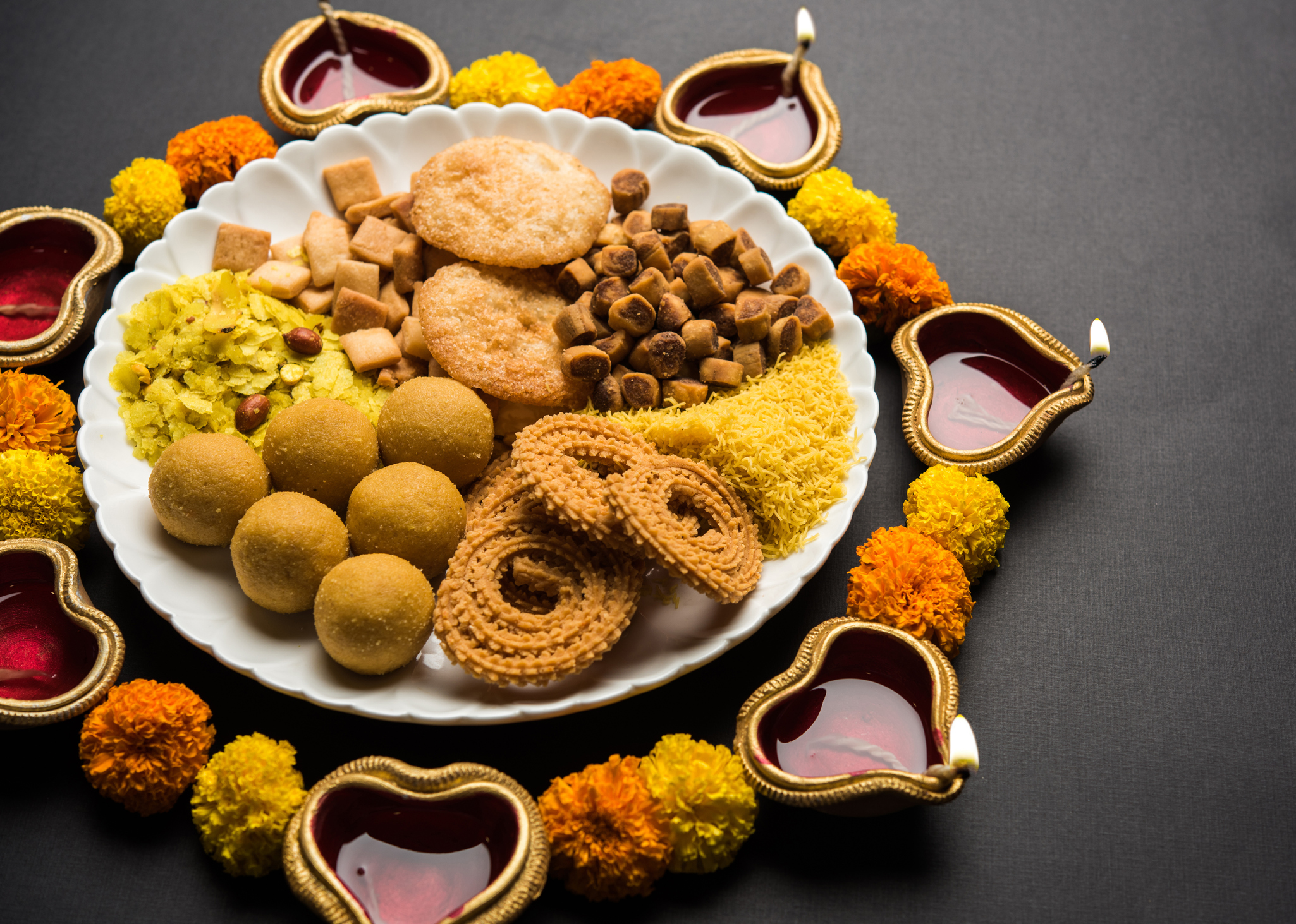 Diwali Rangoli Or Design Made Using Indian Snacks sweet And Diya Or 